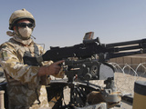 A British Army Soldier Mans a Machine Gun Mounted on Top of a Land Rover