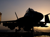 Silhouette of a US Navy F/A-18E Super Hornet on the Flight Deck of USS Nimitz