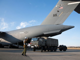 A Japanese Soldier Marshals Vehicles from a C-17 Globemaster III