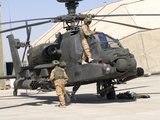 British Soldiers Perform Maintenance on an Apache Helicopter
