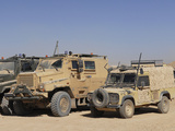 A British Armed Forces Snatch Land Rover Parked Next to Other Military Vehicles