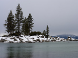 Scenic Snow Covered Rocks and Evergreens on the Shore of Lake Tahoe