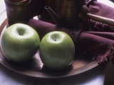 Green Apples on a Plate Alongside a Teapot and Maroon Napkins