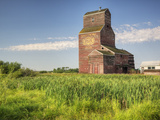 A Derelict Grain Elevator Weathers Away on the Canadian Prairie
