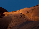 A Man Climbs on the Cat Wall as the Sun Sets