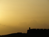 Morro Fortress Silhouetted Against a Sunset Sky