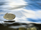 Skipping Stone Just About to Hit the Water's Surface