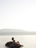 A Woman Sunbathes on a Hot Summer Day by the Ocean