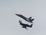 A Us Navy F-18 Hornet an F-4 Corsair Flying in Formation
