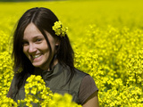 A Young Woman in a Field of Rapeseed  Brassica Napus