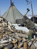 A Nomadic Komi Reindeer Herder Chops Wood to Heat His Family's Chum