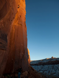 A Man Climbs on the Cat Wall as the Sun Sets