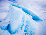 An Iceberg Sits Frozen into the Sea Ice over Winter in the Arctic