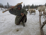 A Nomadic Komi Reindeer Herder Fishes in a Hole with Primitive Gear