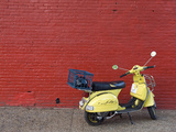 A Yellow Motor Scooter Against a Red Wall in Little Five Points