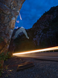 A Boulderer Climbs Next to a Road as Night Falls