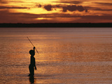 Young Boy Spear Fishing at Sunset in the Mouth of the Kikori River Delta  Papua New Guinea