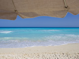 View of Turquoise Waters from Underneath a Beach Umbrella