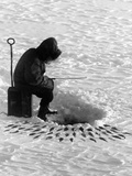 A Fisherman Fishes Through the Ice on Lake Huron