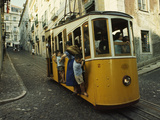 High Quarter Jam-Packed Cable Trolly Descends a Cobblestoned Street