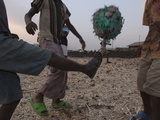 Kids Play Soccer with Ball Made of Plastic and Rubber on Lava Field from Nyiragongo's 2002 Eruption