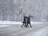 A Trio of Pedestrians Rush Through the 'Blizzard of 2010'