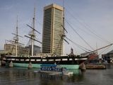 A Water Taxi Passes US Constellation in Baltimore's Inner Harbor
