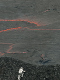 A Volcanologist  Wearing a Thermal Suit  Approaches an Active Lava Lake