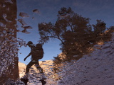 Reflections of Sandstone Cliffs  Trees and a Hiker in a Creek