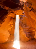 Sunlight Streams Through Cracks in a Slot Canyon