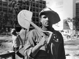 A Workman Shoulders a Shovel after Work on a New Apartment Building