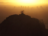Silhouetted View of Phoenix  Arizona and a Hill at Sunset