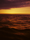 A Dramatic Sky Casts a Red Glow over Waves on Lake Michigan