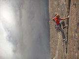 A Climber  Without a Rope  Jams Her Hands into Fissures for Ascent