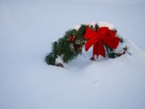 Bright Red Bow of a Cemetery Christmas Wreath Buried in Fresh Snow