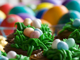 Easter Eggs and Cupcakes Decorated Like Eggs in Lush Grass