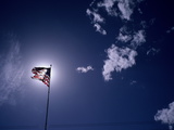 An American Flag Against a Glowing Sun