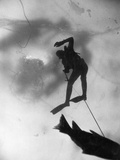 An Ice Fisherman Drags a Carp Upward Toward a Hole in the Lake's Ice