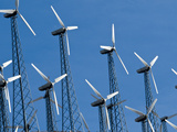 Looking Up at Windmills Against a Clear Blue Sky