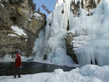 Boy Looking Up at the Frozen Upper Falls in Johnston Canyon