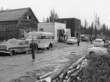 Locals Walk Down Muddy Main Street of Atomic Mineral Mining Town