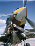 A Pilot Adjusts His Oxygen Mask in Front of an Airplane