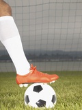 View of a football players foot on a soccer ball