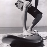 Young Man Standing on Surfboard on the Beach