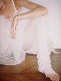 Ballet Dancer Wearing Tutu Sitting on Floor