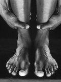 Man holding ankles