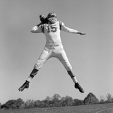 1960s Quarterback Jumping And Throwing Pass Football