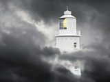 Lighthouse Emerging From Dark Clouds
