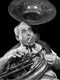 1940s Chubby Man Musician With Polka Dot Bow Tie And Bulging Eyes Playing A Sousaphone