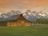 Log Barn in Meadow near Mountain Range
